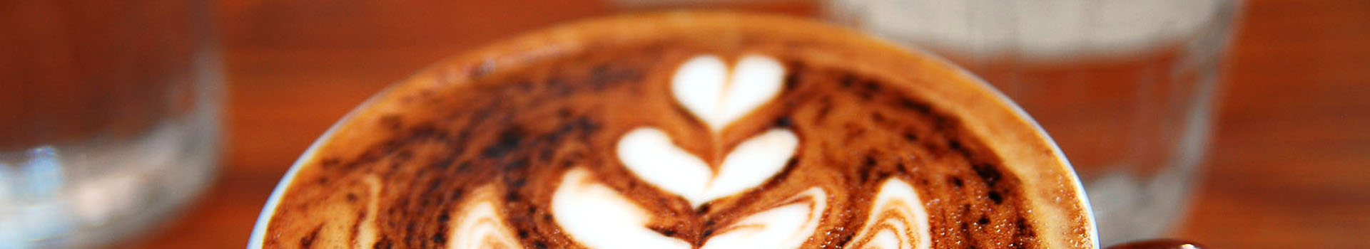 Close-up image of a coffee with a rosetta pattern